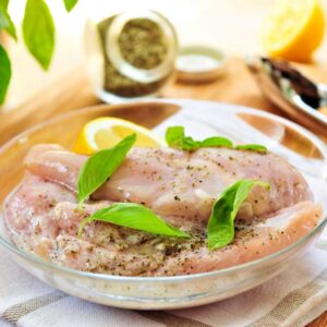 Marinated chicken breasts with herbs and lemon.